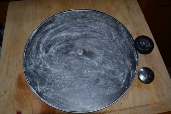The cover of my wok. I unscrewed the handle part and floured it up and it worked great as a stand in pizza pan LOL